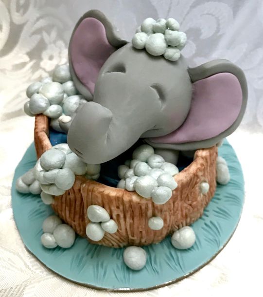 Cute Elephant splashing in a tub cake topper.