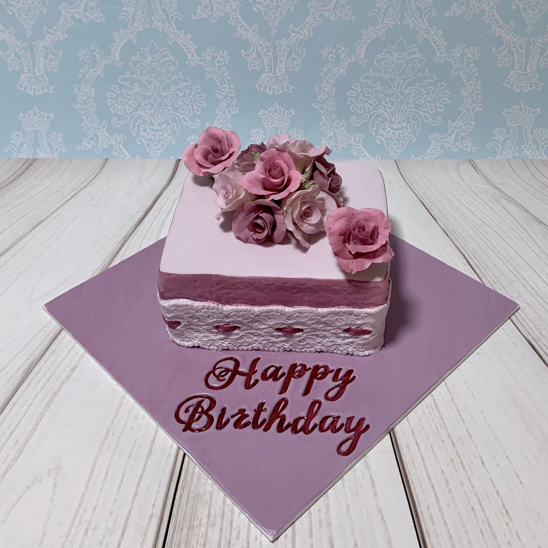 Pretty Birthday Cake with a Sugar Roses and fondant lace in soft pinks and mauves.