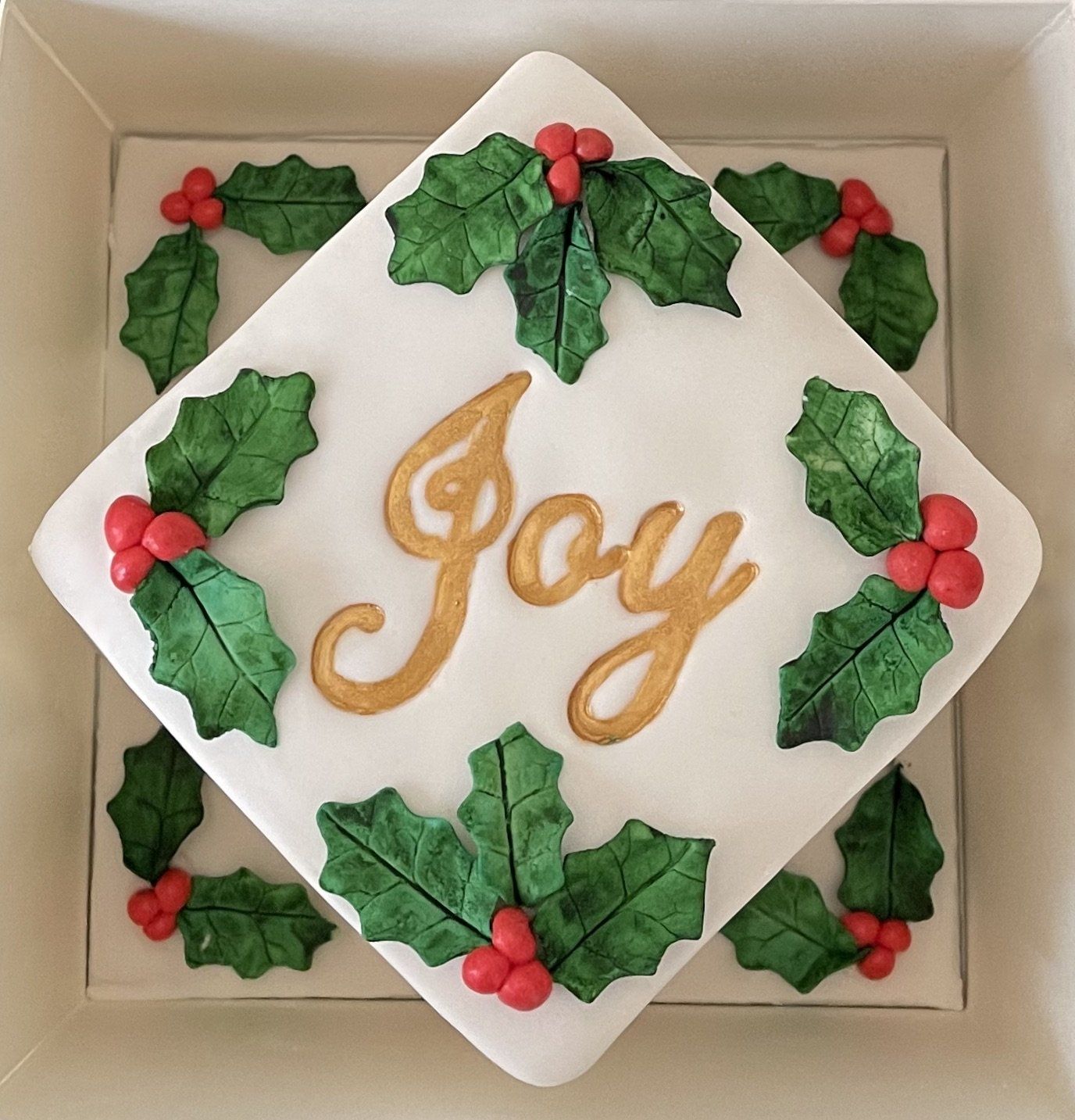 Boxed Christmas cake with Fondant Holly and the word Joy