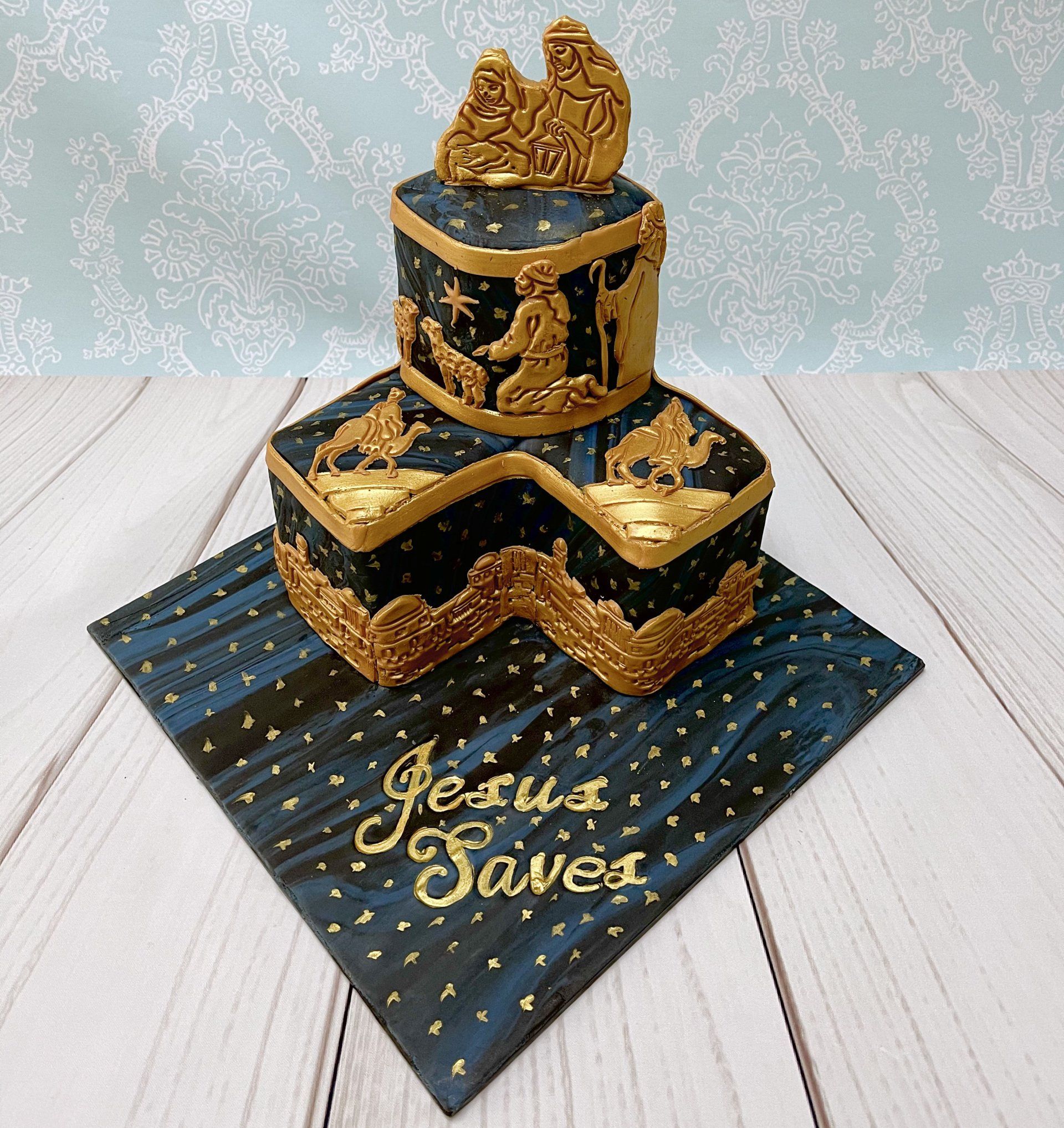 Two Tier Christmas cake with navy marbled fondant, and Gold Nativity fondant Scenes