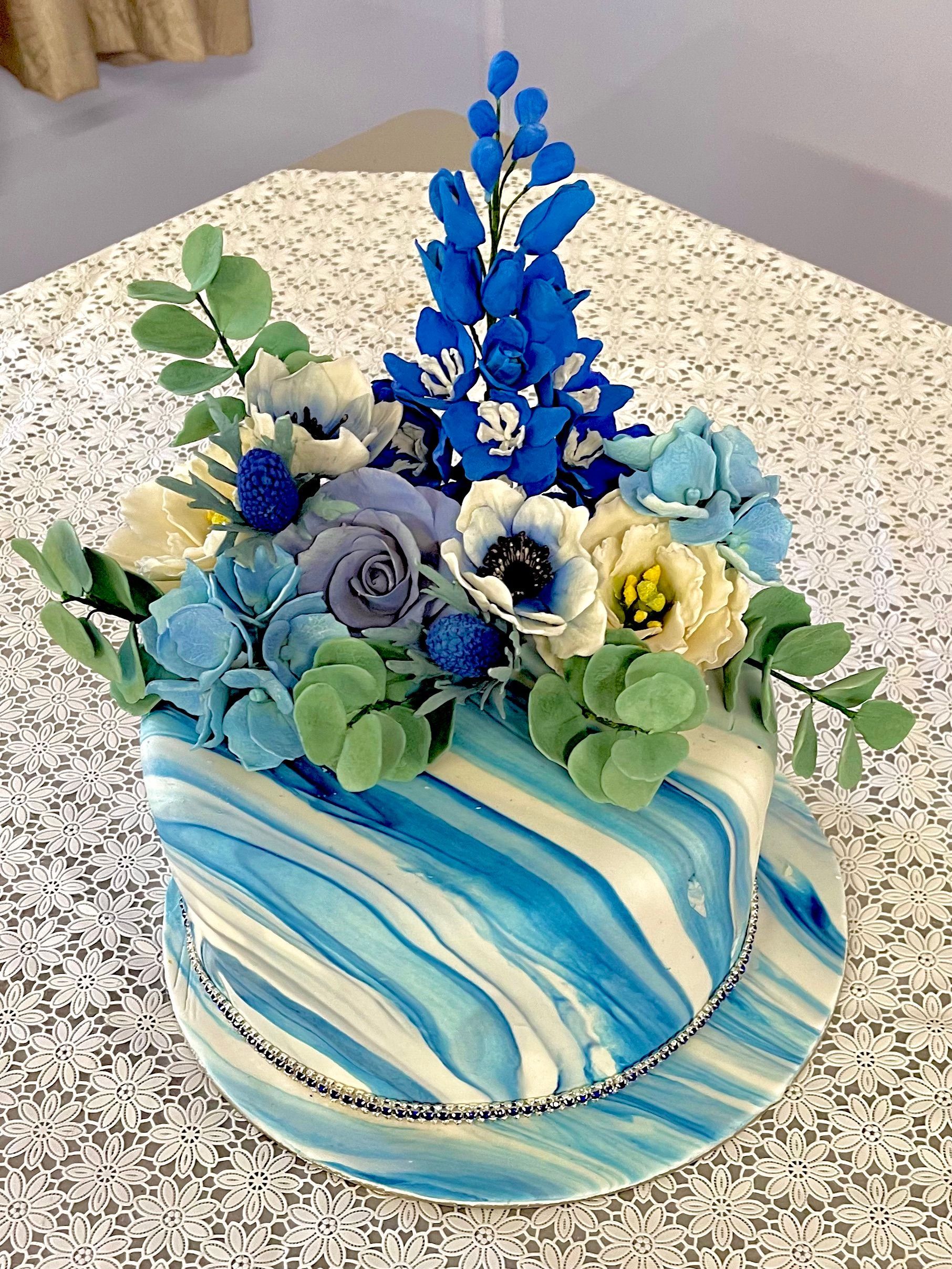 Sapphire wedding anniversary cake with marbled fondant and handmade sugar flowers in shades blue.