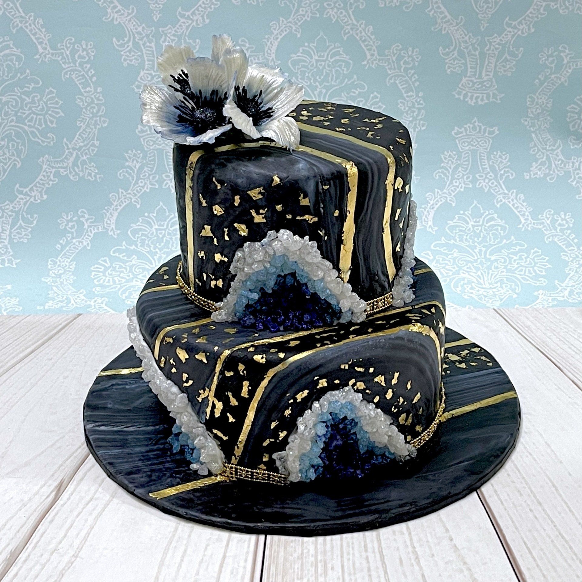 Geode Cake with Black marbled fondant, Blue sugar goeodes, gold leaf and sugar fantasy flowers.