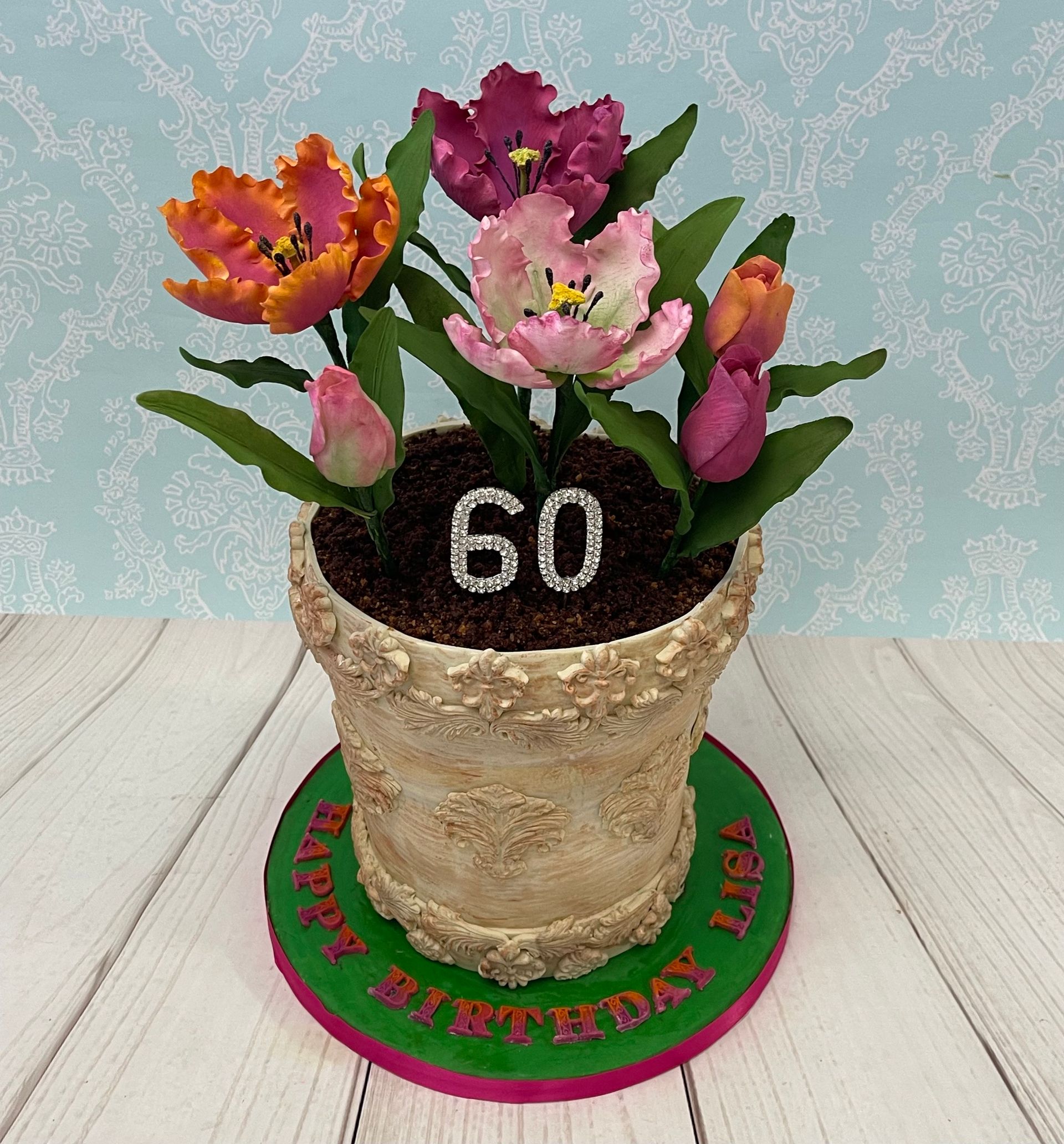 Birthday Cake decorated to look like a pot of flowers with handmade sugar tulips.