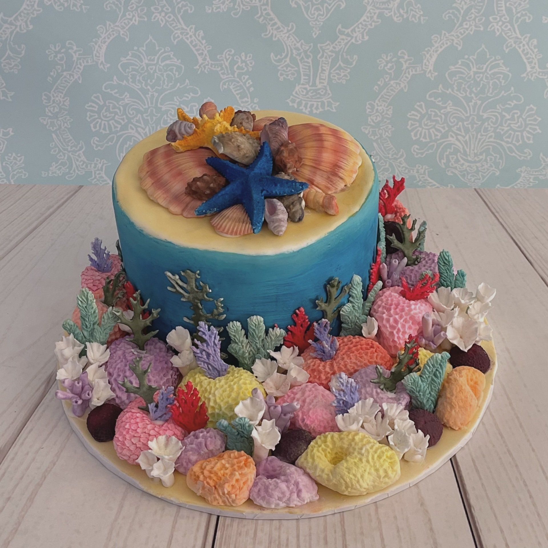 Birthday cake with handmade fondant corals and fondant shells,