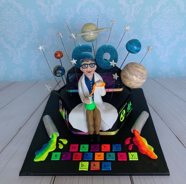 Science themed cake with hand sculpted scientist and planets