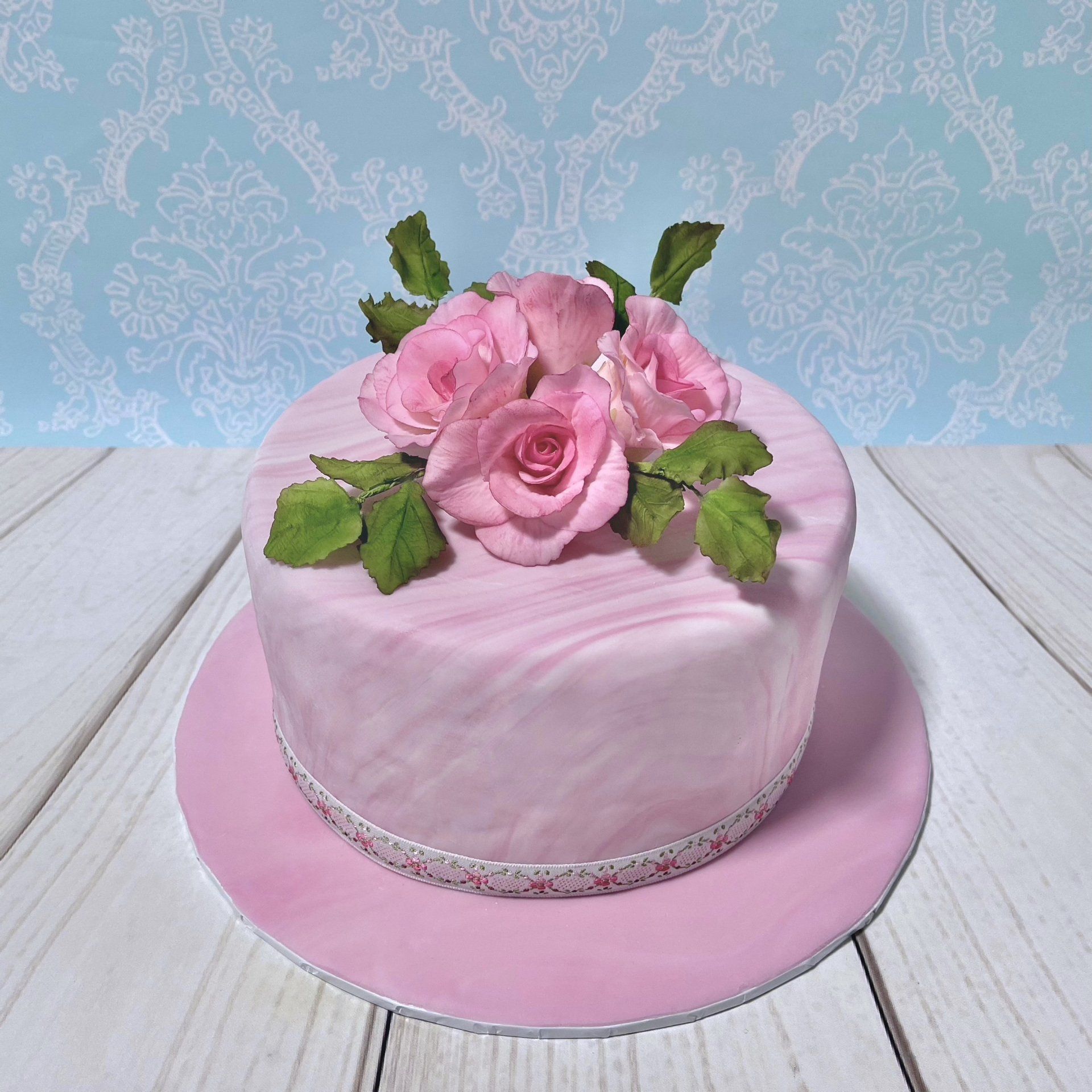 Pretty Birthday Cake with Pink Sugar Roses and Pink marbled fondant.