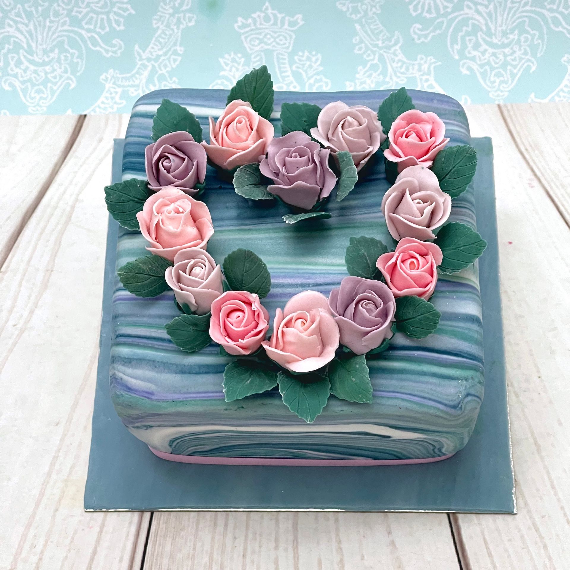 Birthday Cake with Marbled fondant and decorated with sugar Roses in the shape of a heart