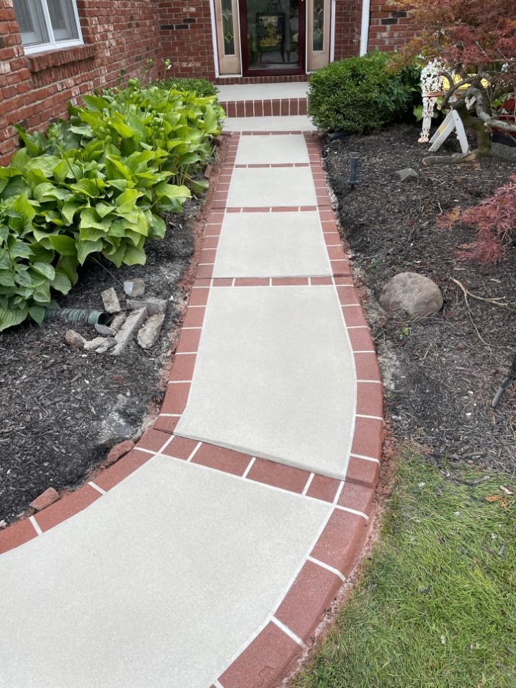 A brick walkway leading to the front door of a house.