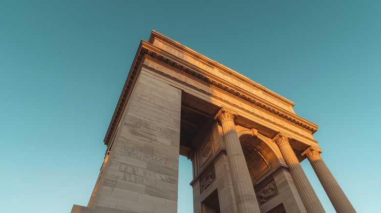 Image of a monument with columns shot from below looking toward the sky
