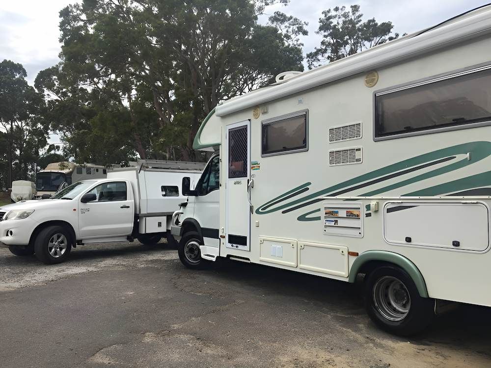 A Rv Is Parked Next To A Truck In A Parking Lot — All Clean Auto Detailing In Caves Beach, NSW