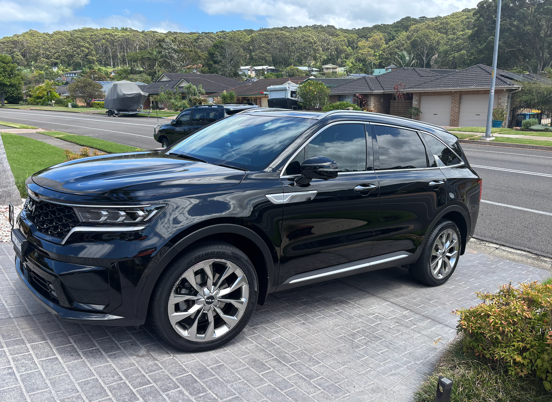 A Person Is Cleaning A Red Sports Car With A Towel — All Clean Auto Detailing In Caves Beach, NSW