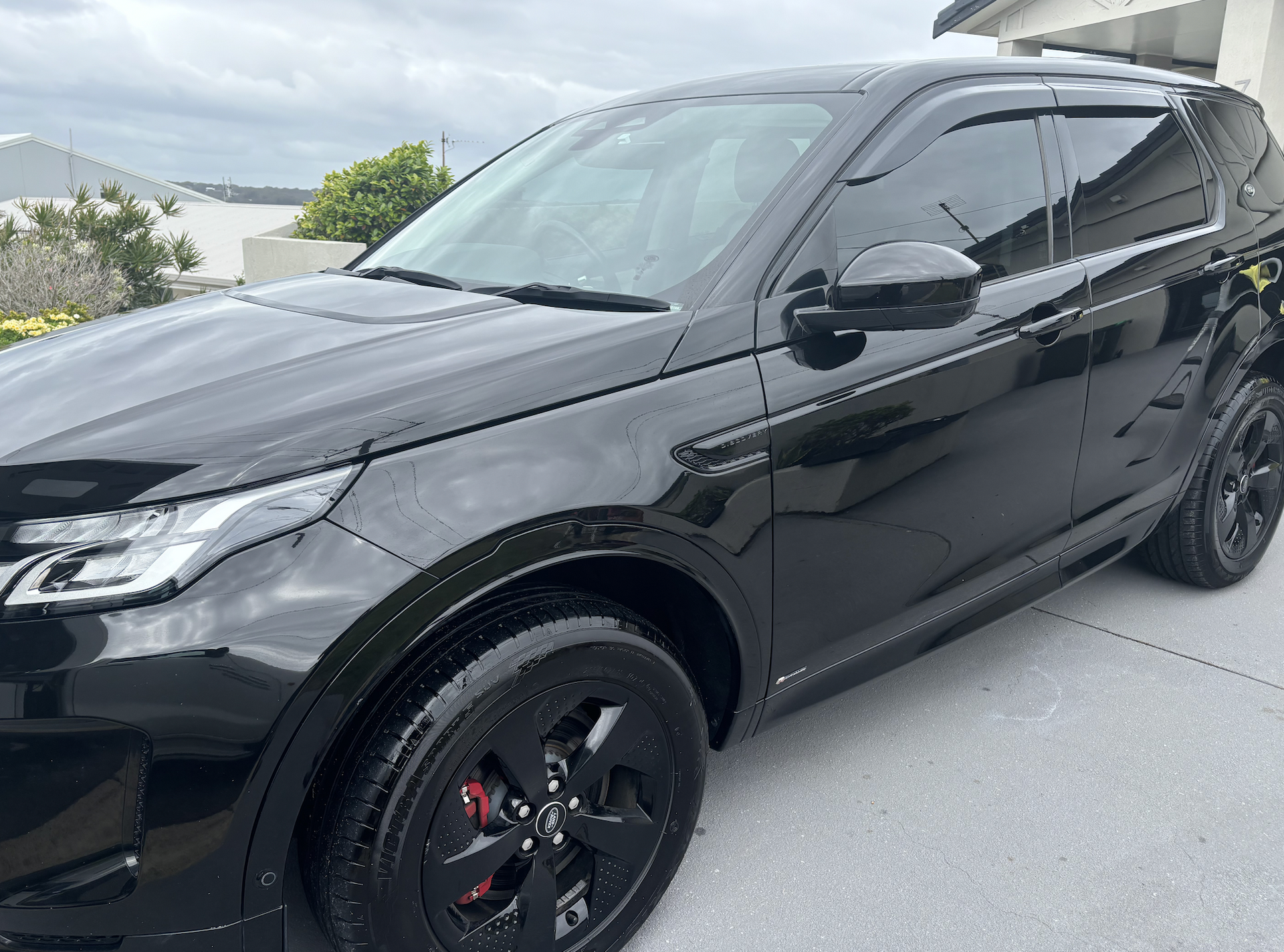 A Red Car Is Parked On The Side Of The Road — All Clean Auto Detailing In Caves Beach, NSW
