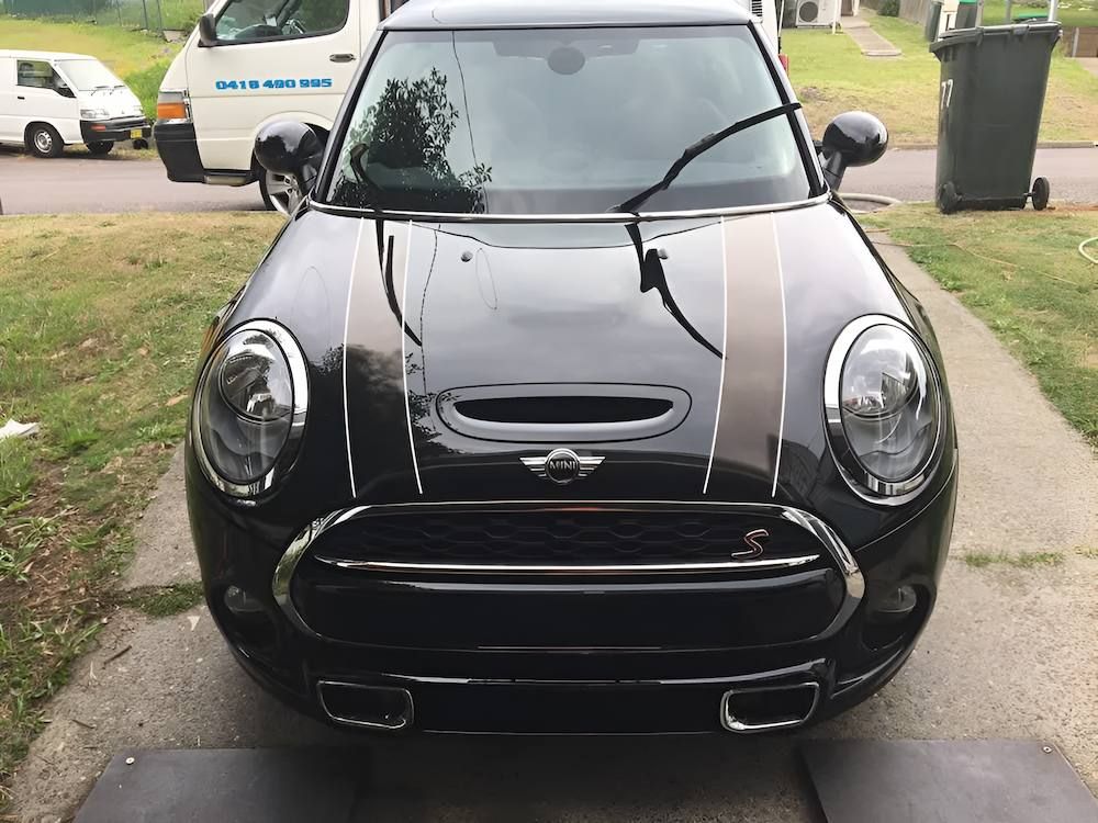 A Black Mini Cooper Is Parked On The Side Of The Road — All Clean Auto Detailing In Summerland Point, NSW