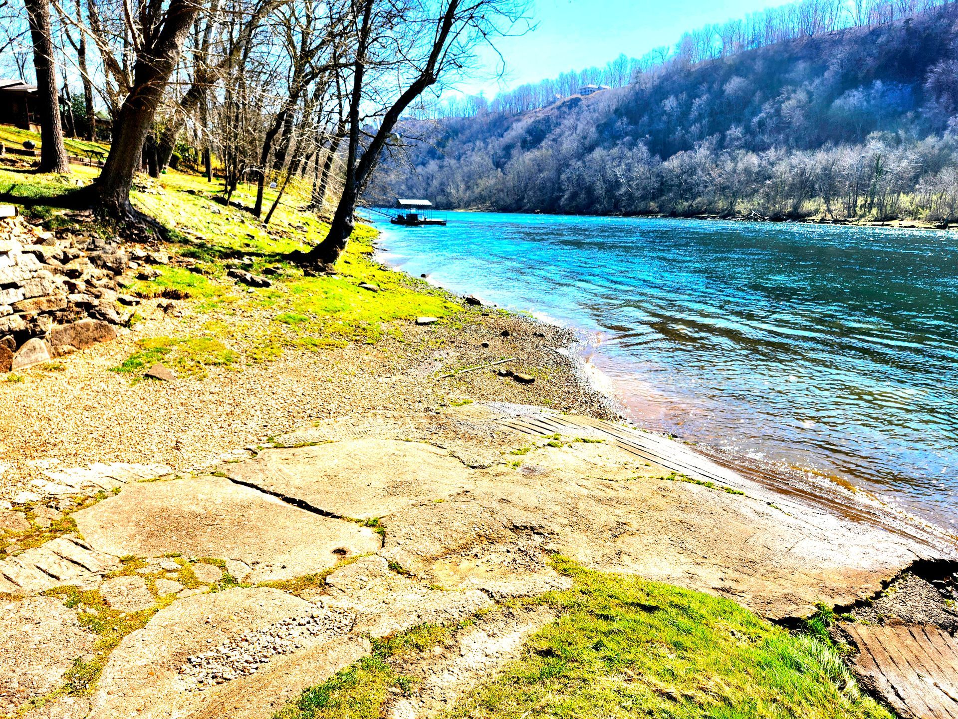 A river with trees on the shore and mountains in the background