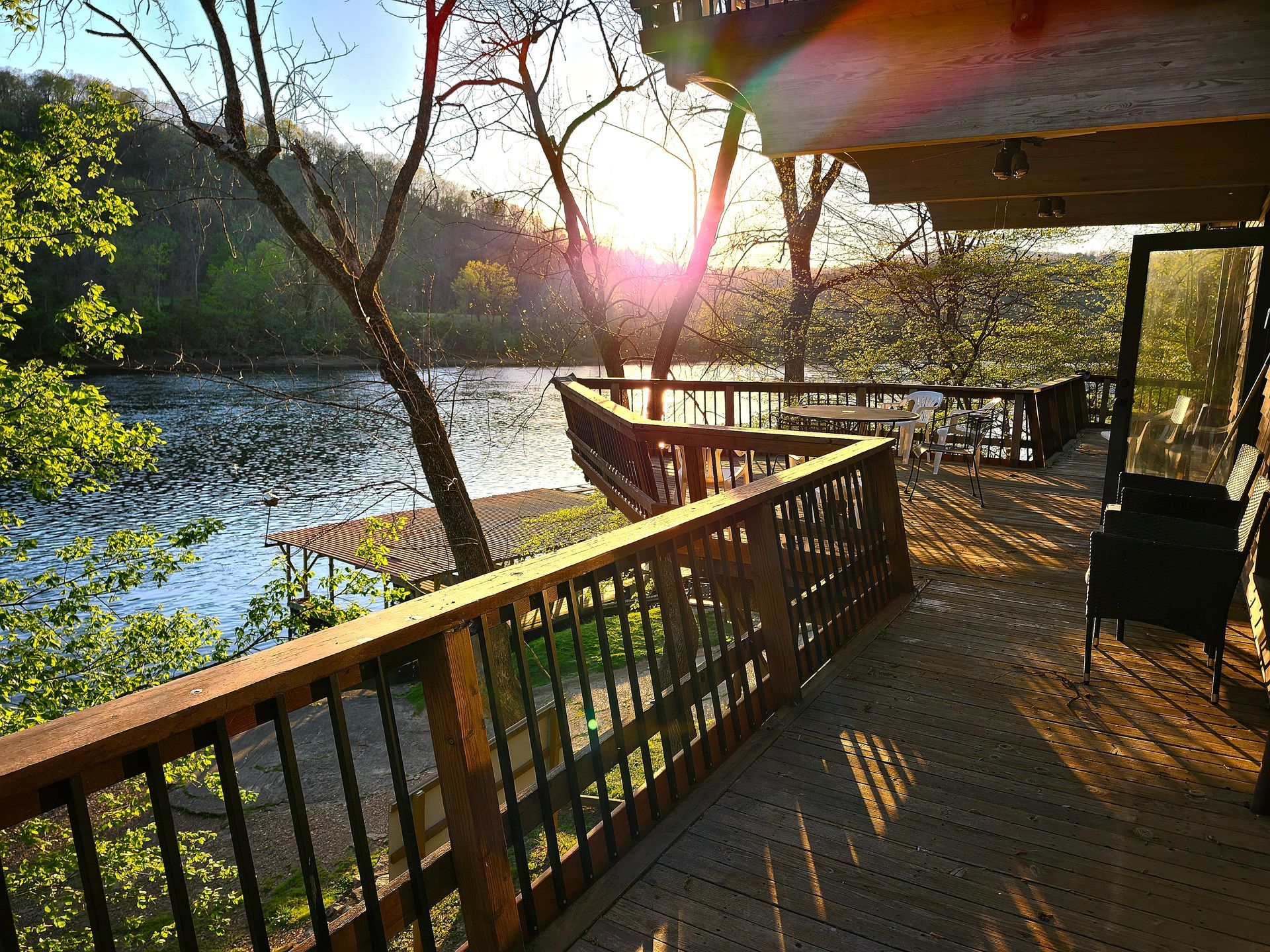 A deck with a view of a lake and trees