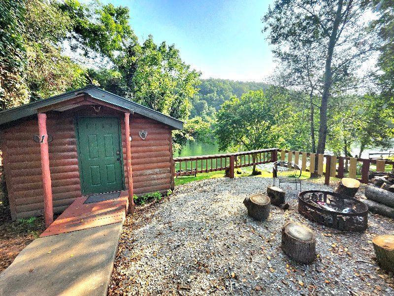 log cabin on white river with seating around firepit copper johns resort cabin 1