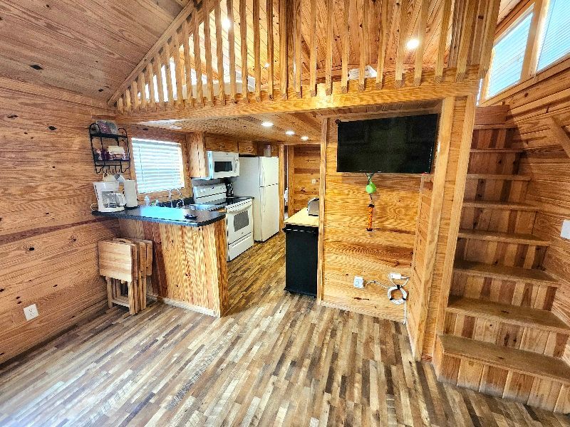 cabin with a full kitchen and loft bedroom at copper johns resort