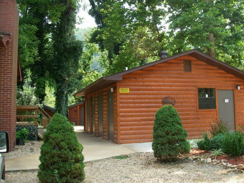 A log cabin with a yellow sign on the side that says caution