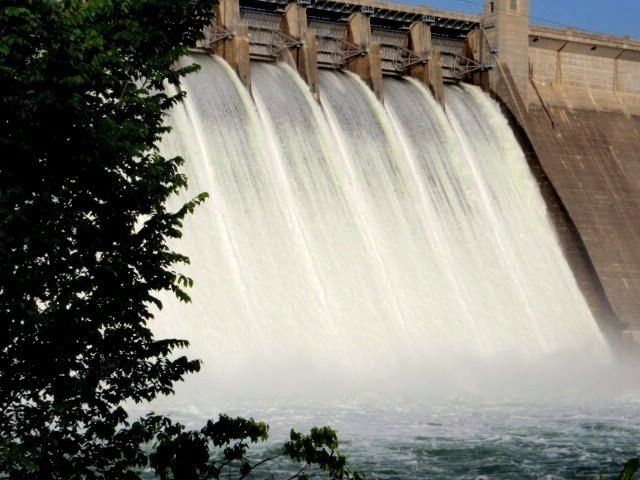 A large waterfall is being created by a dam