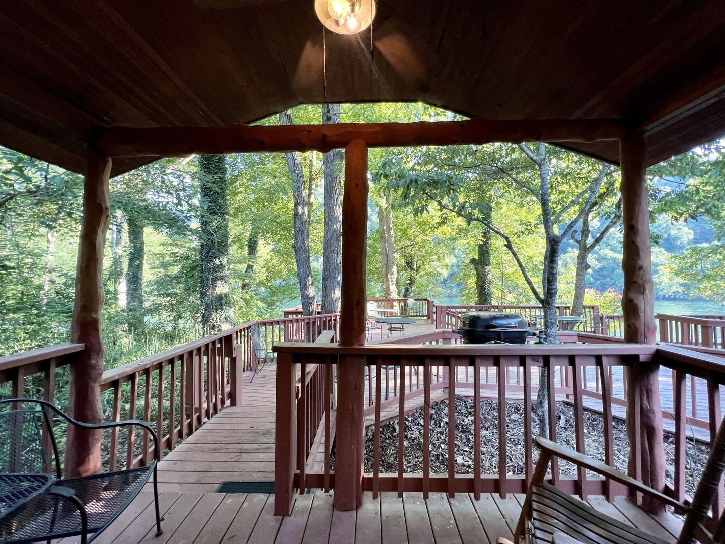 Copper johns resort cabin with deck in the forest with a view of the river.