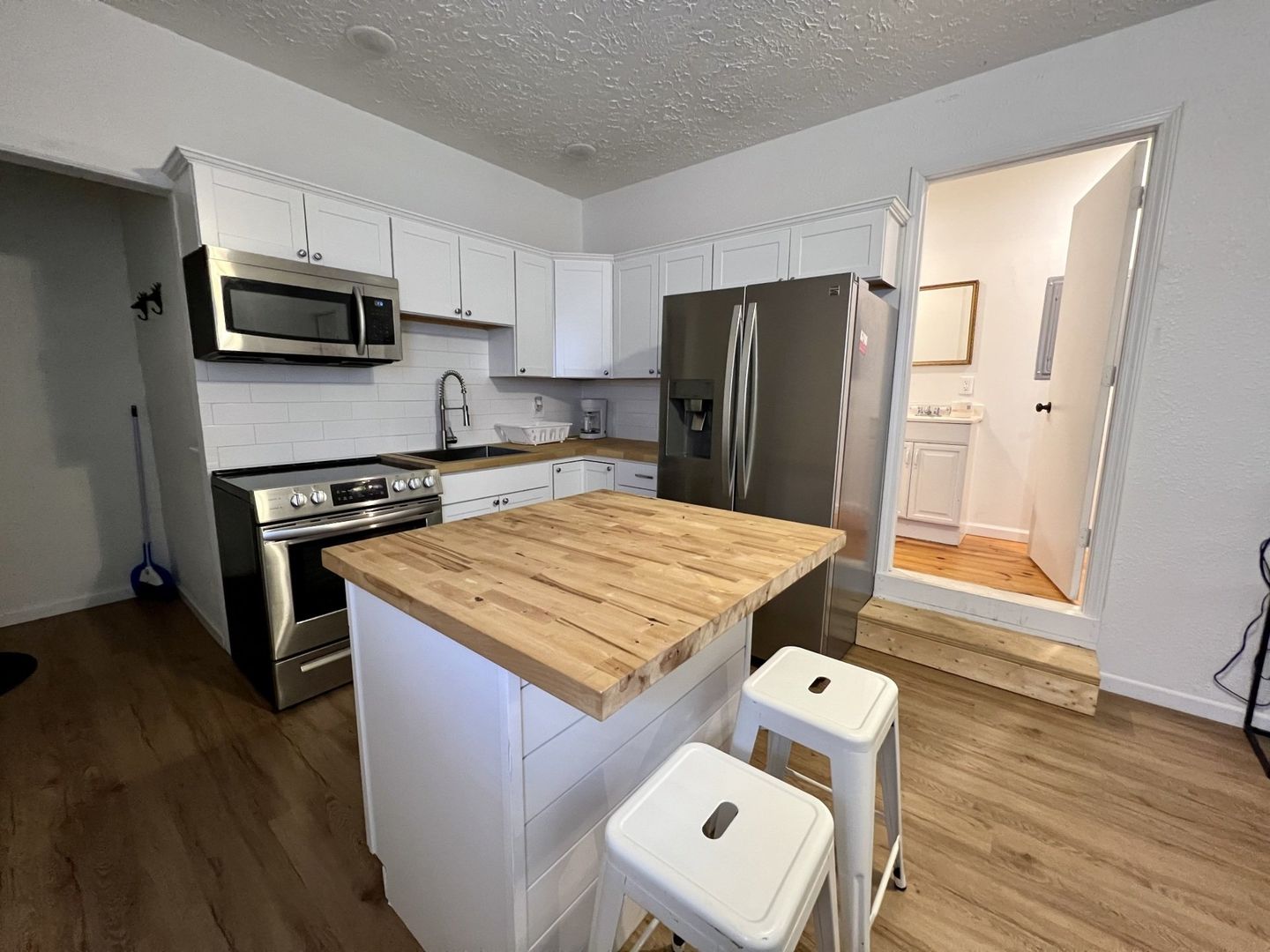 kitchen with butchers block and stainless steel appliances in a cabin at copper johns resort