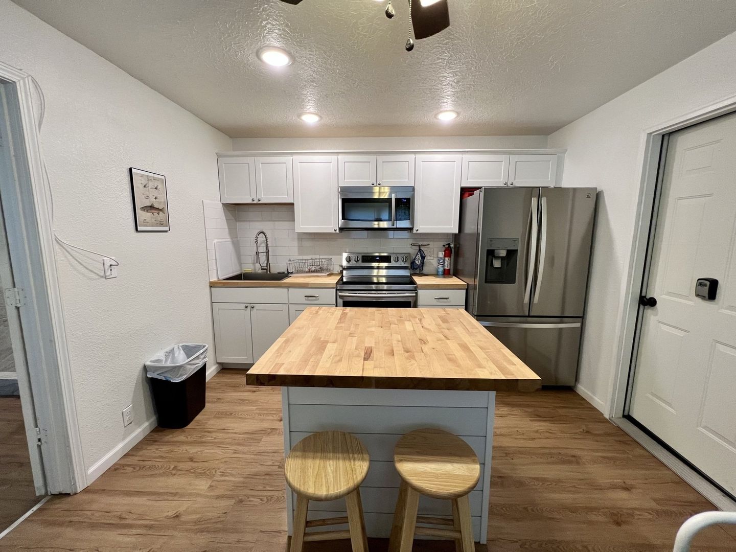 A kitchen with stainless steel appliances and a wooden island in a cabin at copper johns resort