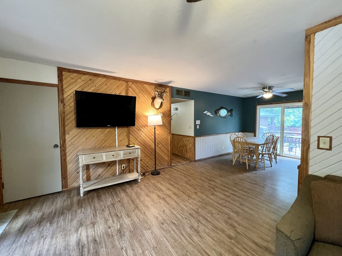 A living room with a flat screen tv and dining table and chairs at copper johns resort