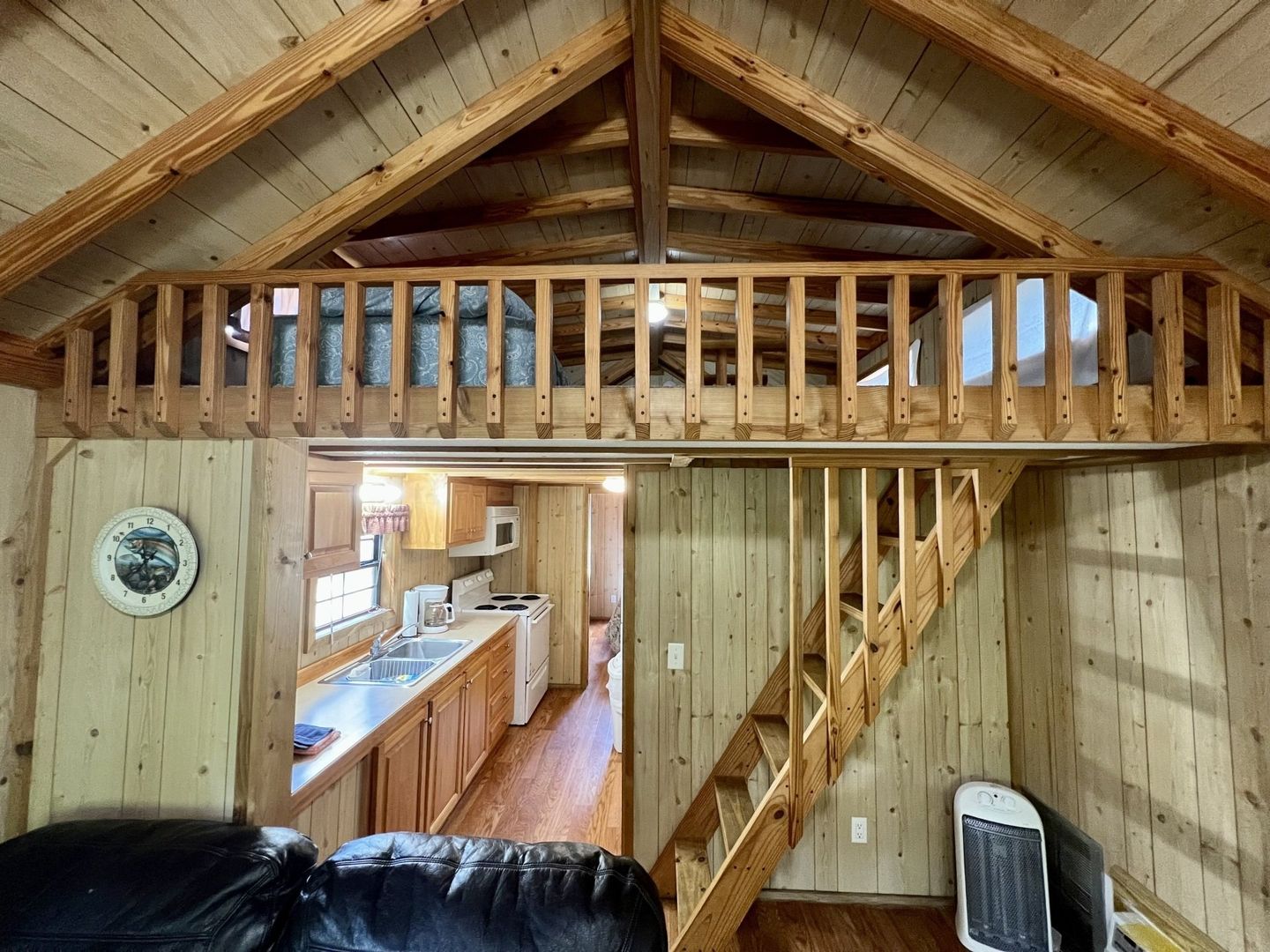 log cabin with a full kitchen and a bedroom in the loft at copper johns resort