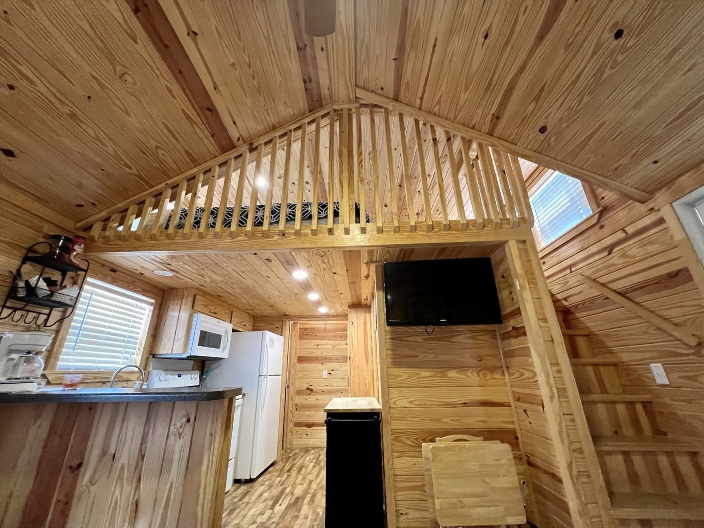 log cabin with loft, tv, coffee pot, microwave and fridge at copper johns resort