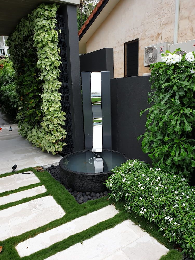 Modern Outdoor Space With Vertical Garden, Water Fountain, and Stone Pathway — Cairns Metal Works in Portsmith, QLD