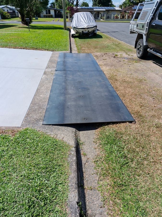 Black Metal Ramp Over a Gutter in Front of a Driveway and a Lawn — Cairns Metal Works in Portsmith, QLD