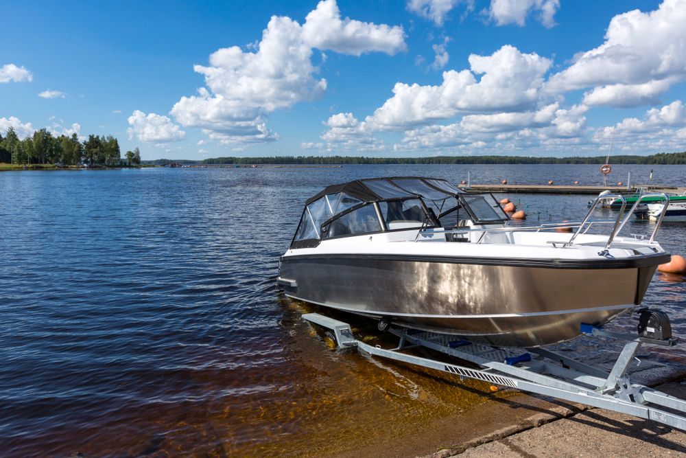 Boat on a Trailer Near Water on a Sunny Day With Clouds — Cairns Metal Works in Portsmith, QLD
