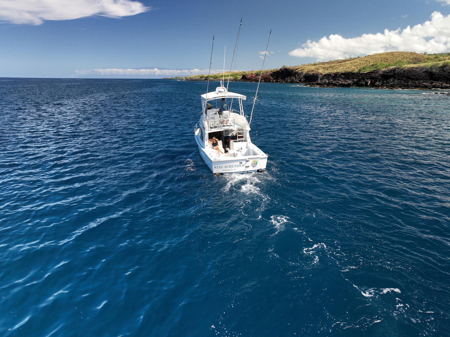 A boat is floating on top of a large body of water