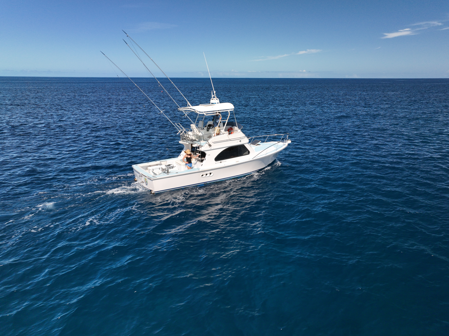 A white boat is floating on top of a large body of water.