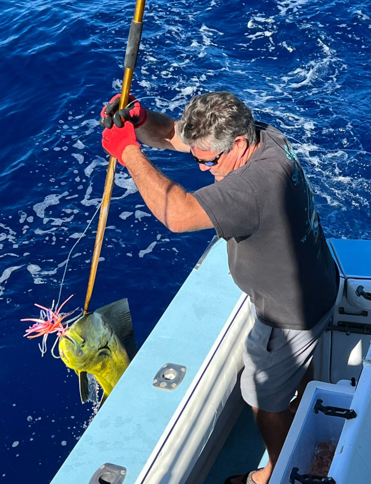 A man is fishing in the ocean with a fishing rod
