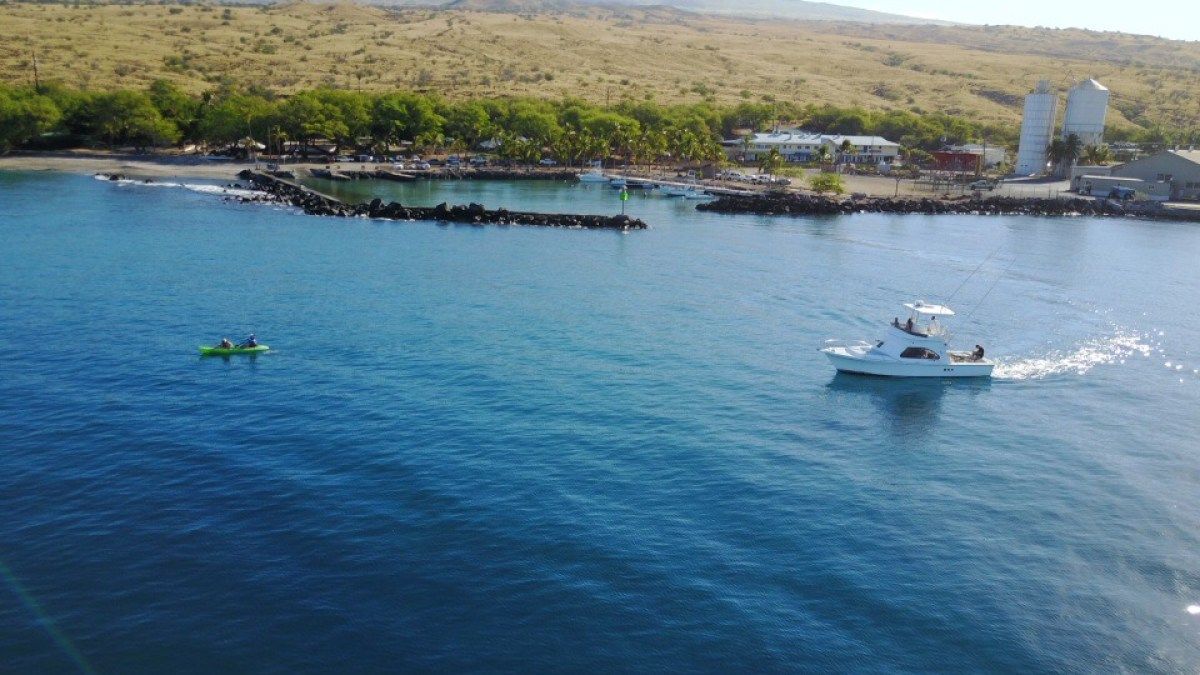 An aerial view of a boat floating on top of a body of water.