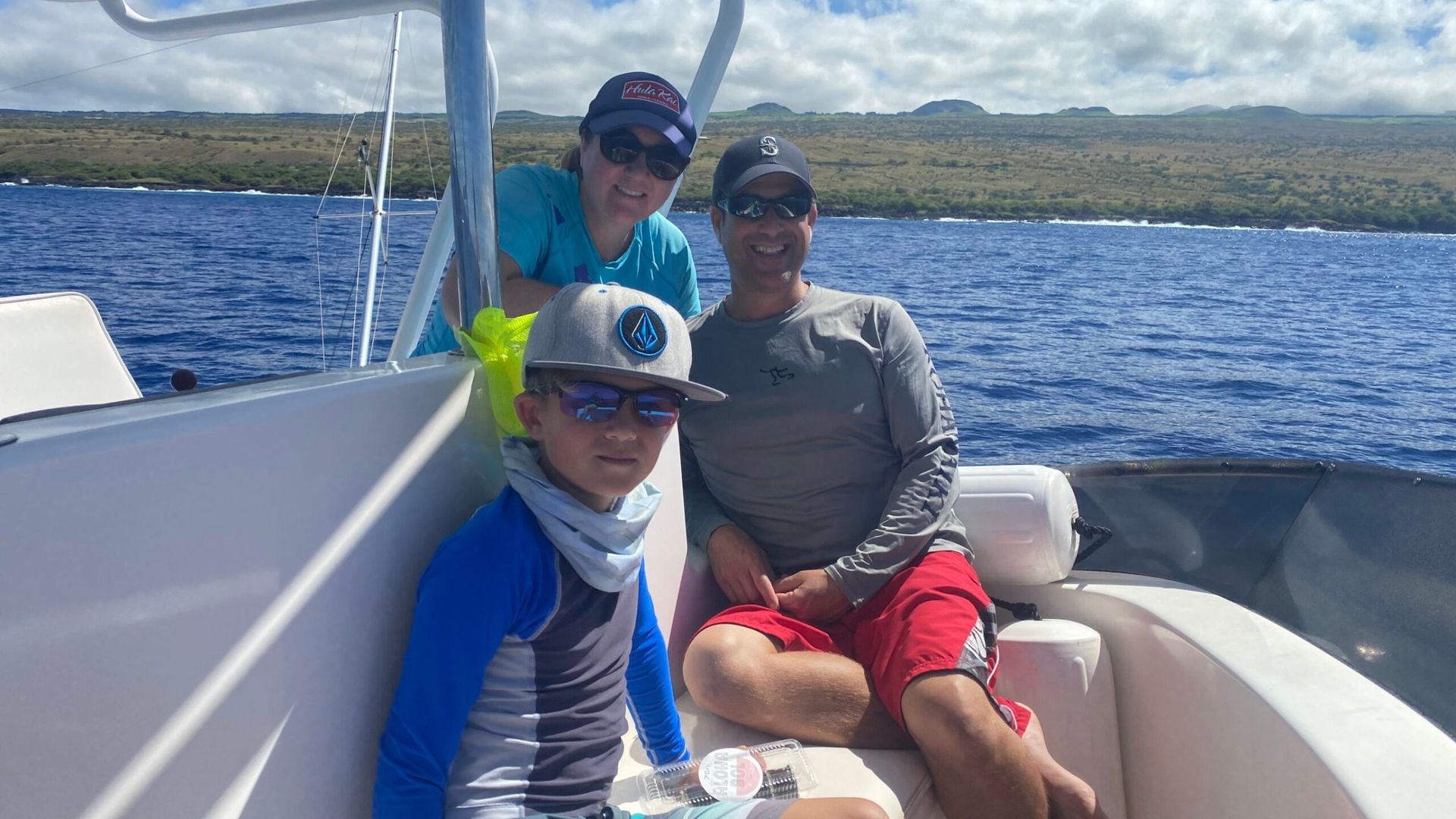 A group of people are sitting on a boat in the ocean.