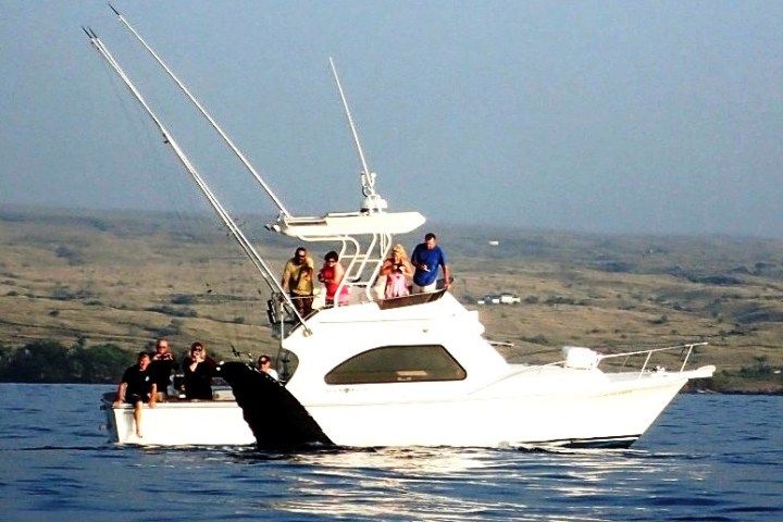 A group of people are on a boat in the ocean
