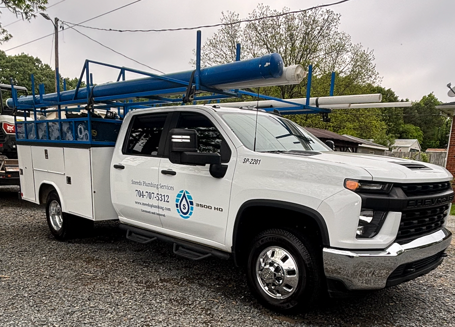 a man wearing a blue hard hat is working on a pipe