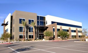 A large building with palm trees in front of it