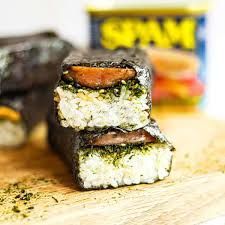 A close up of a spam sandwich on a cutting board.