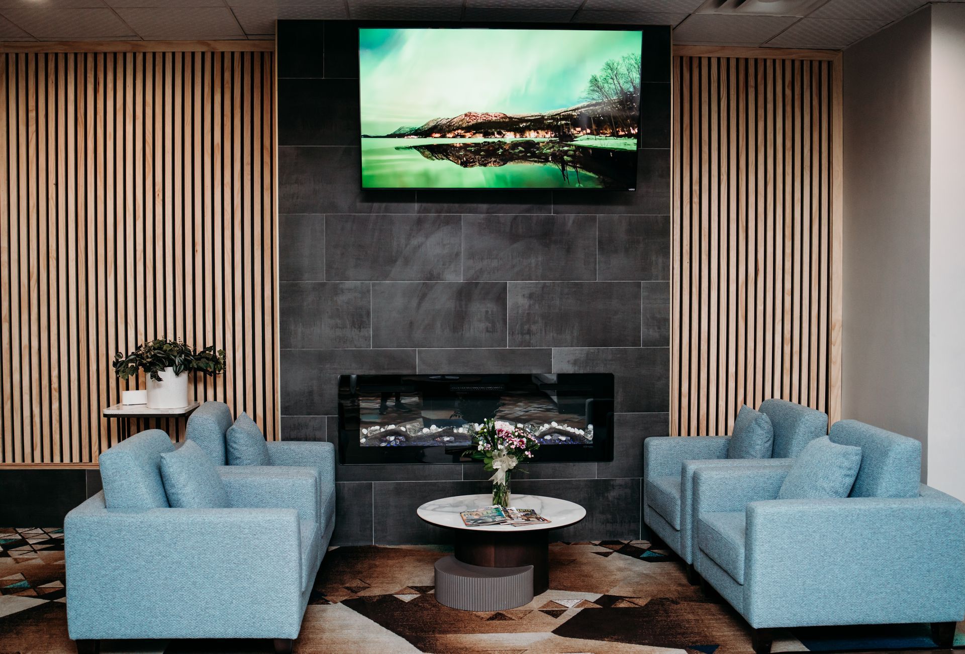 Woman holding an iPad talking to an assistant wearing cleaning gloves