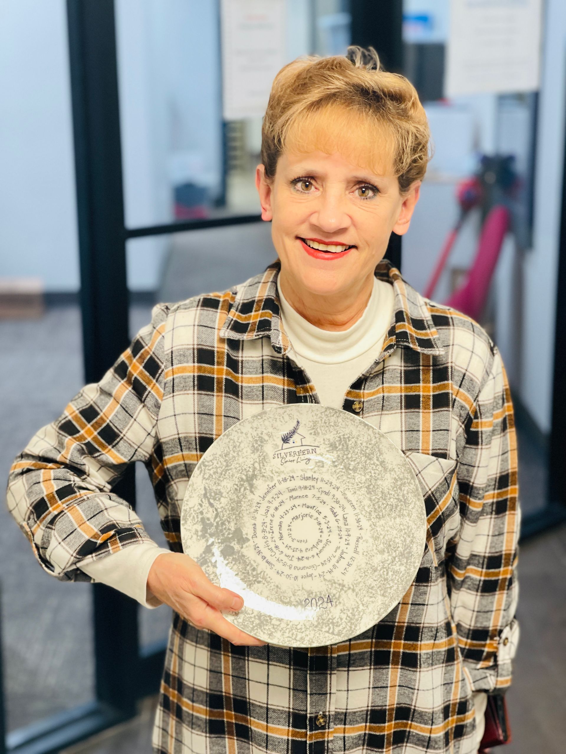 Someone holding a commemorative Silverfern plate from the art & ceramic studio 