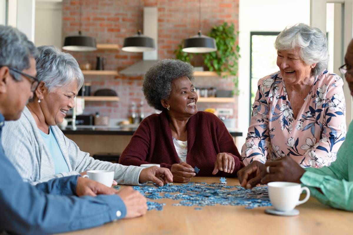 Five seniors putting a puzzle together and enjoying conversation near Cincinnati, Ohio (OH)