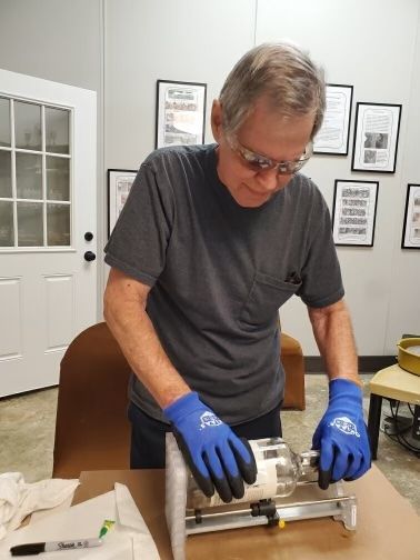 A man working on an art project in the art & ceramic studio