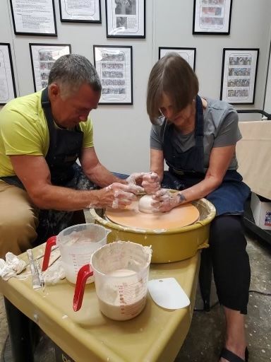 Two community members working on a ceramics project together in the art & ceramic studio