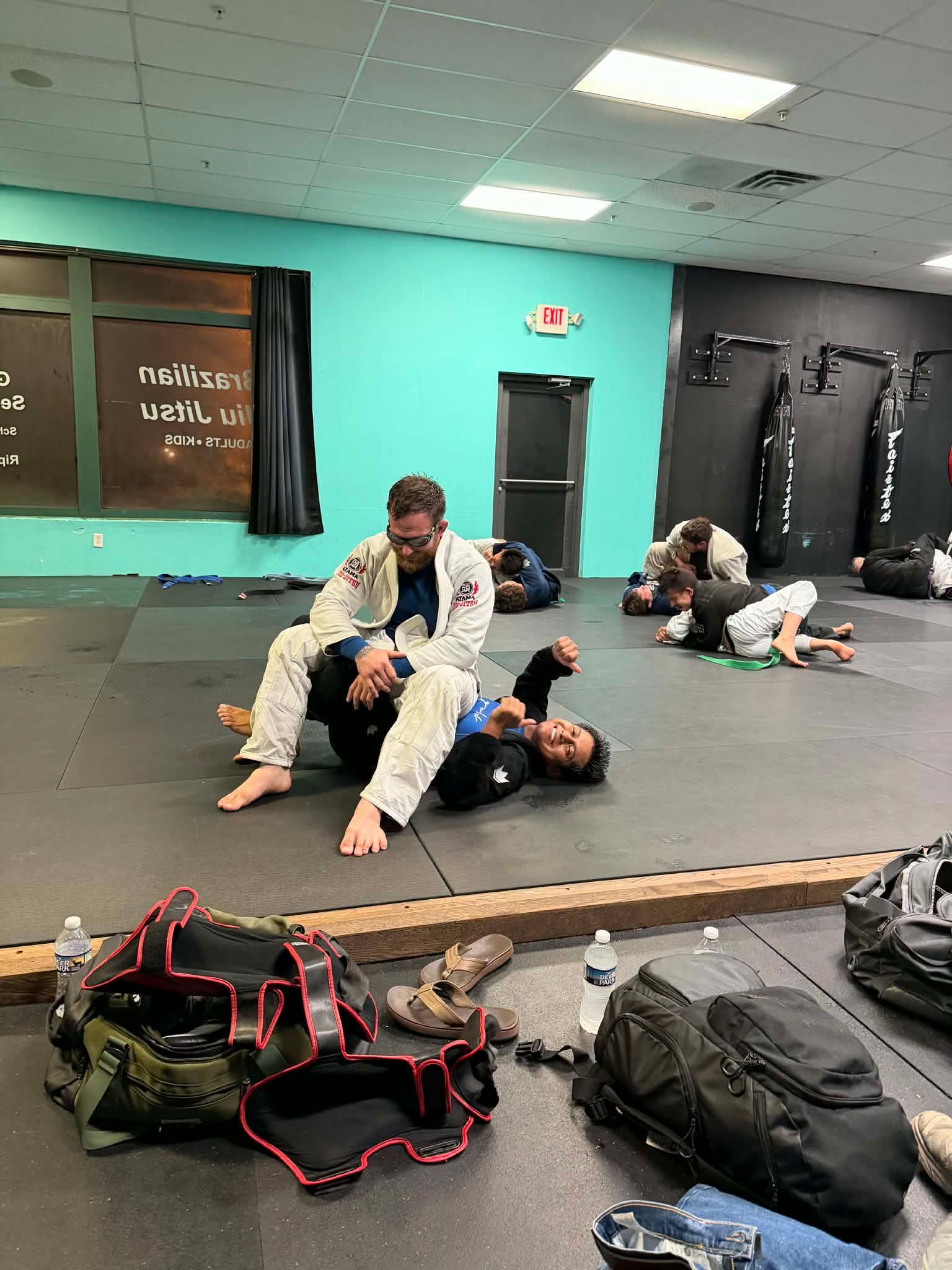 Adult students drilling Brazilian Jiu-Jitsu techniques at Rip Tide Brazilian Jiu Jitsu in Lewes, DE for fitness and confidence.