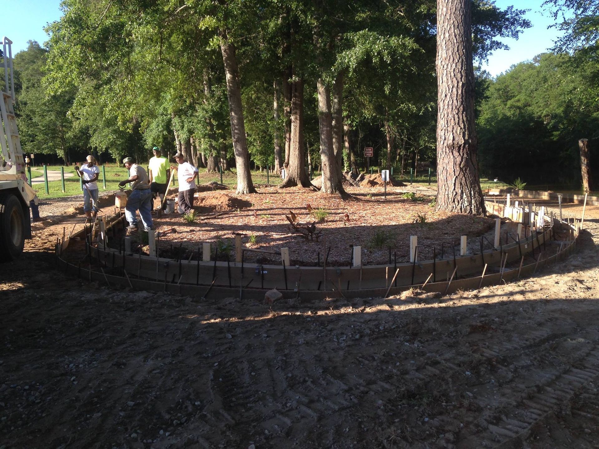 A group of people are working on a construction site in the woods