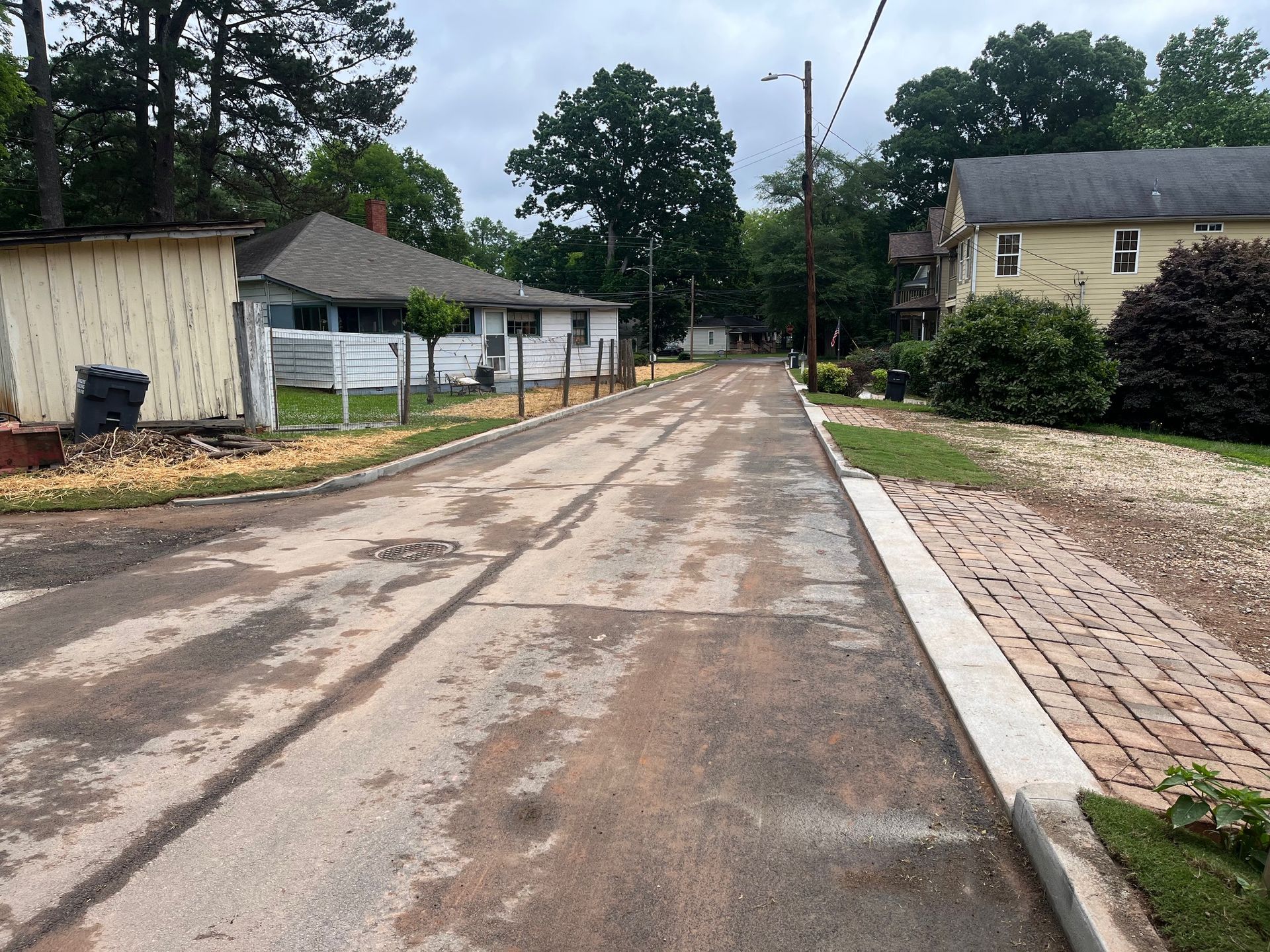 A man is working on a concrete curb in a park