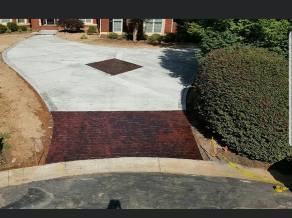A concrete driveway with a diamond design in the middle